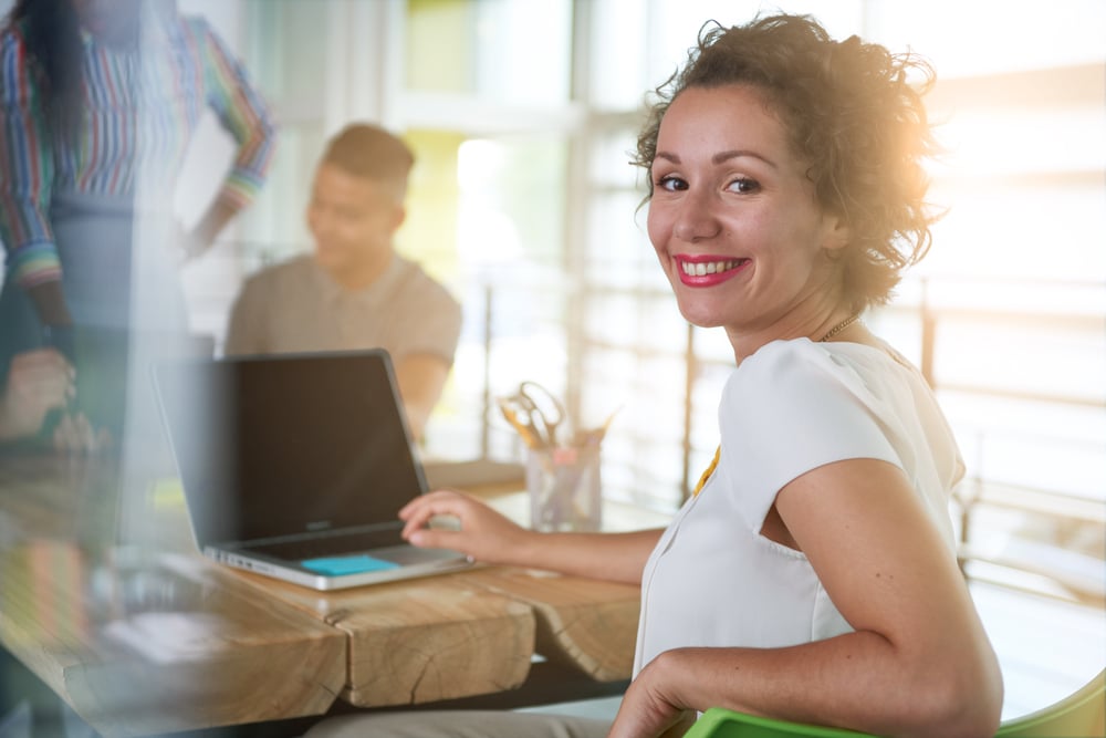 Image of a succesful casual business woman using laptop during meeting-1