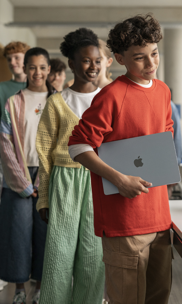 Group of students receiving Apple devices for education
