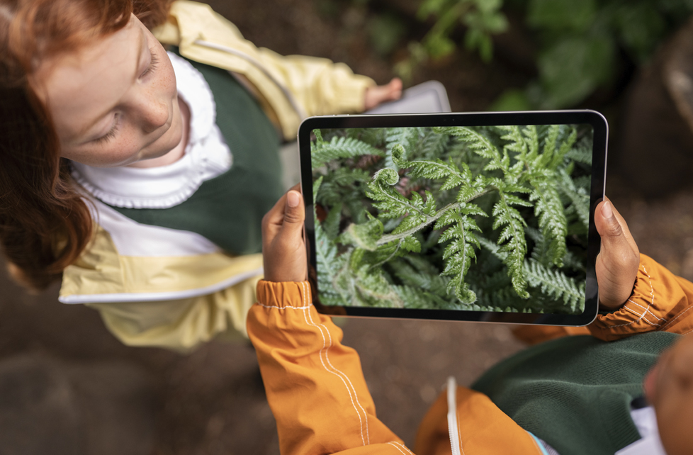 Students capturing images of plants using iPads