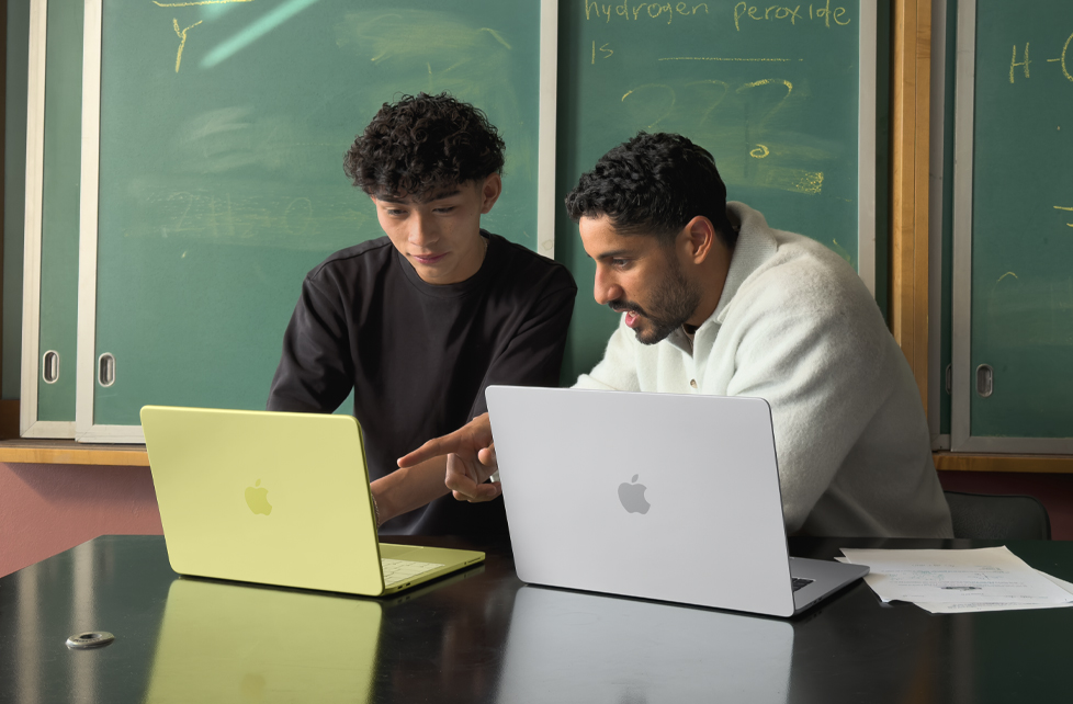 Student and teacher using MacBook Neo laptops in classroom